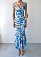 Blue and white patterned dress on a plain background