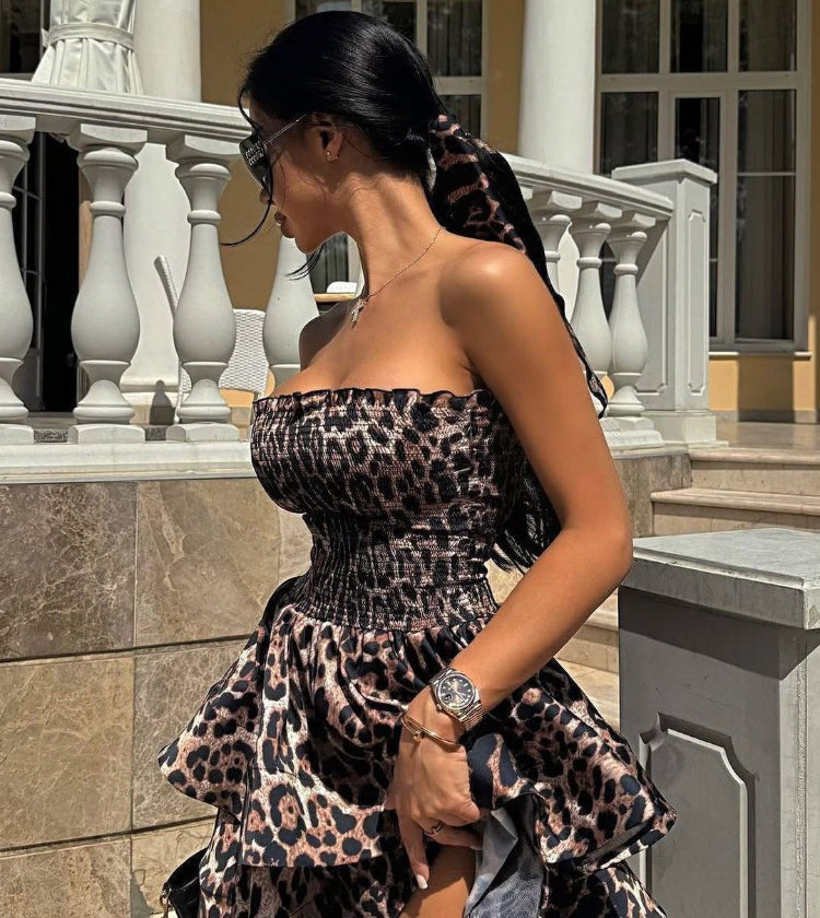 Woman wearing a leopard Tiger print dress standing outdoors.