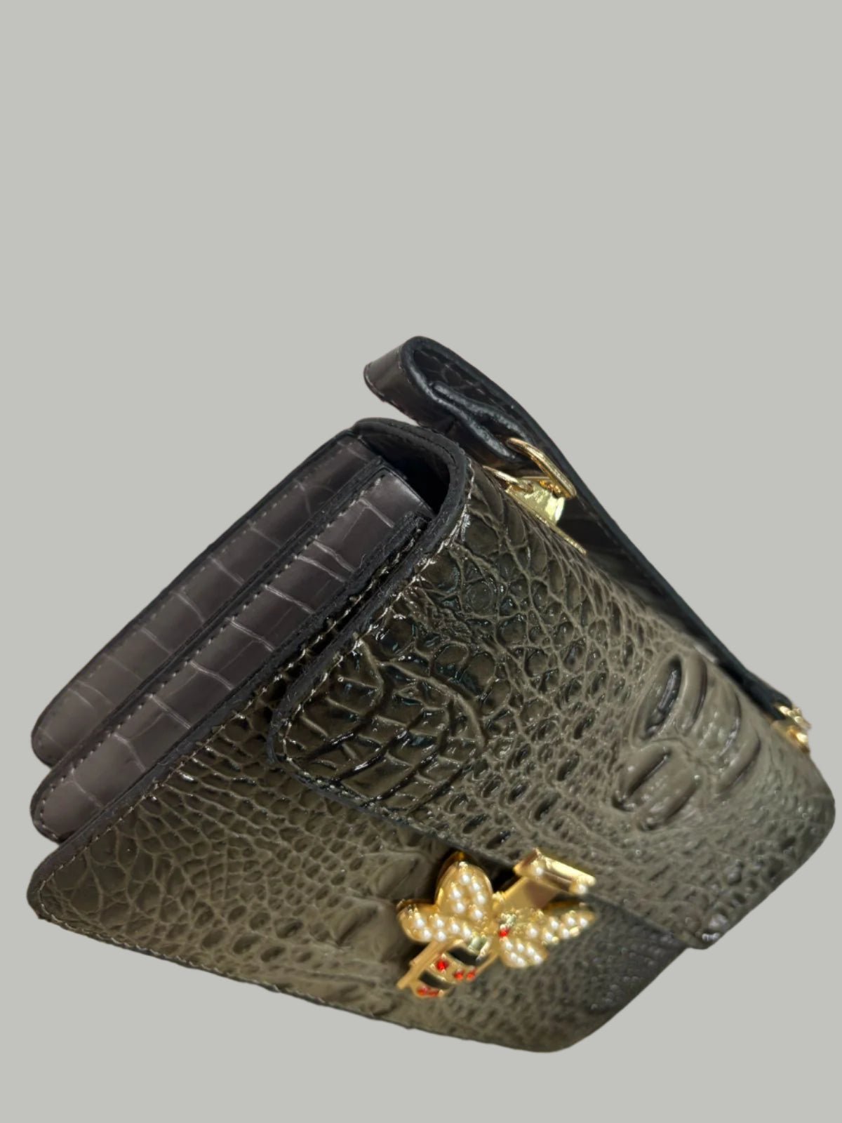 Black textured leather wallet with a decorative clasp.