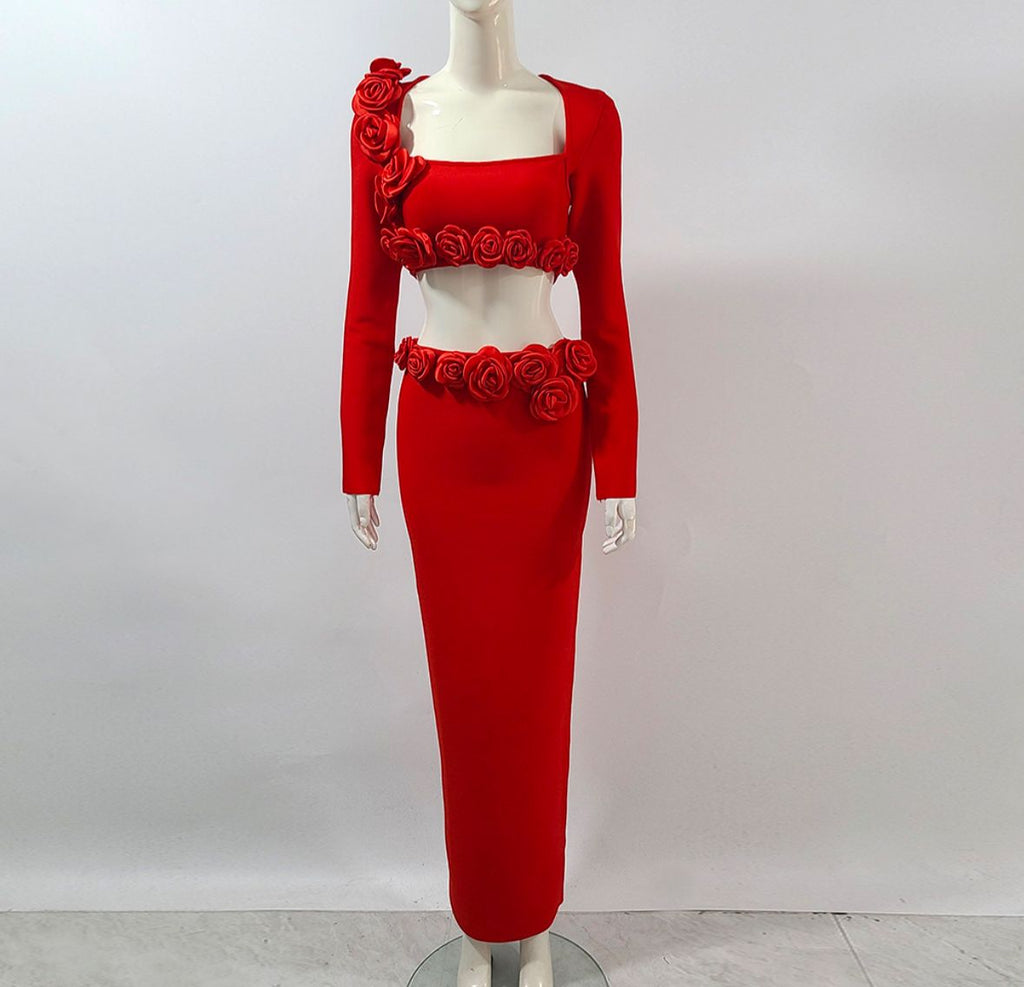 Red dress with floral embellishments on a mannequin against a white background