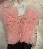 Pink bodysuit on a hanger against a floral wallpaper background