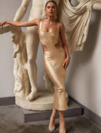 Woman in a gold dress standing