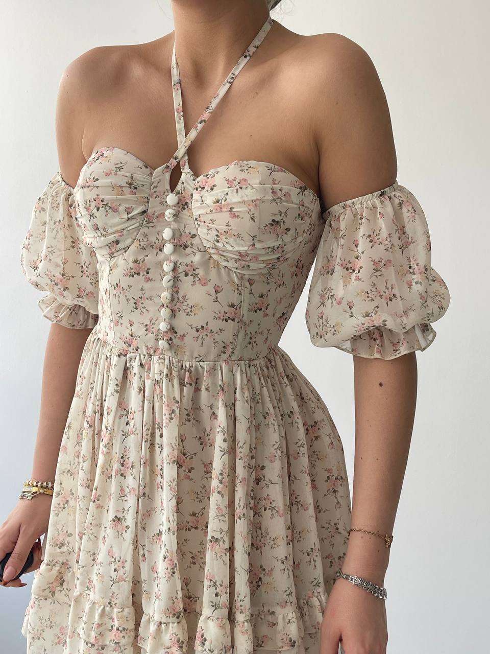 A floral dress with off-shoulder neckline, puff sleeves. The dress features a Empire waist and a flared skirt.