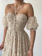 A floral dress with off-shoulder neckline, puff sleeves. The dress features a Empire waist and a flared skirt.