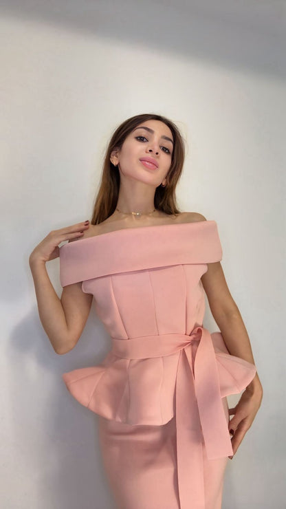 Woman wearing a pink off-shoulder set against a white background