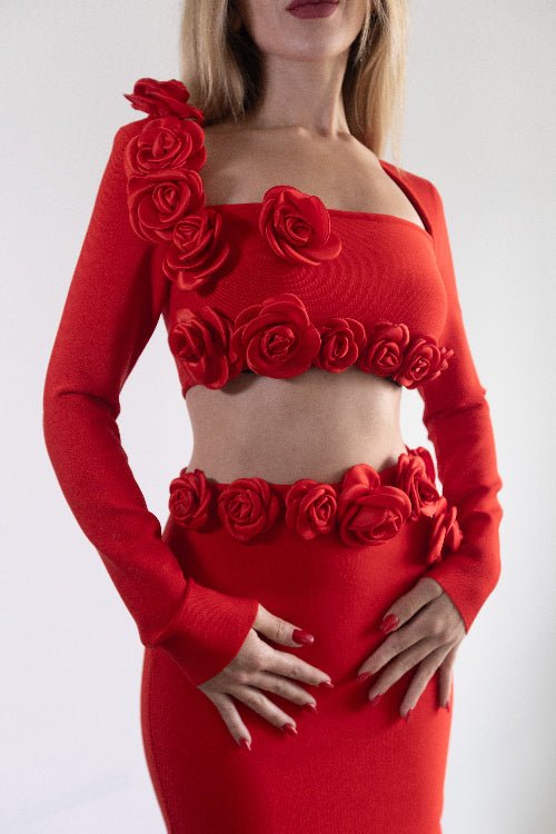 Red outfit with floral embellishments on a white background