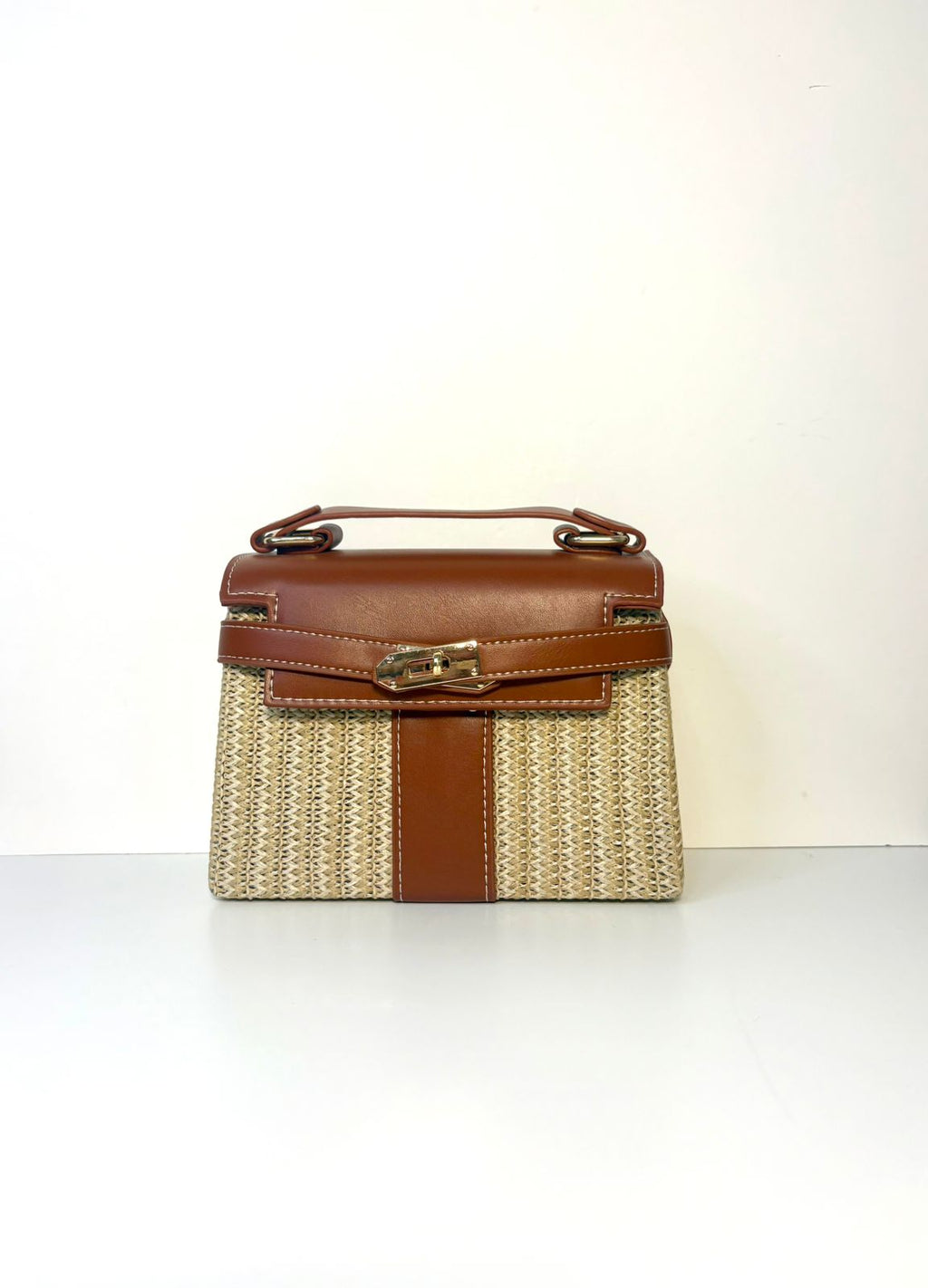 Brown and beige handbag on a white background