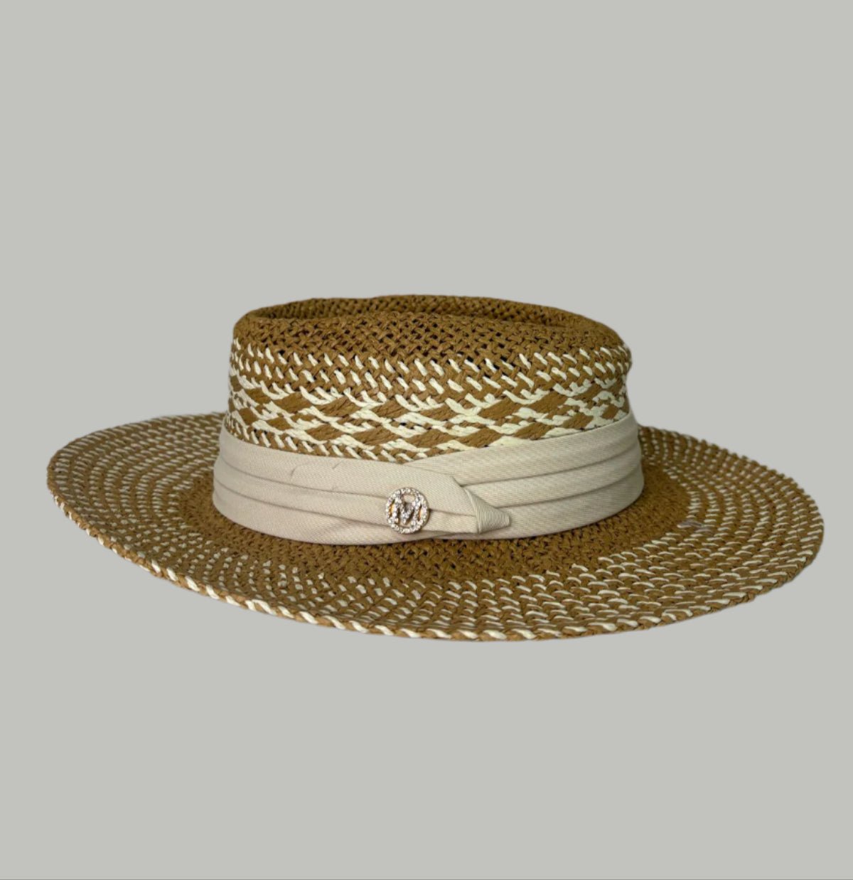 Straw hat, beige on a white surface with a decorative background.