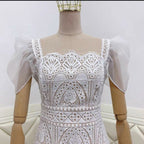 White lace dress on a mannequin against a white background