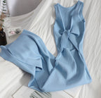 Light blue sleeveless dress with a knot detail on a white surface