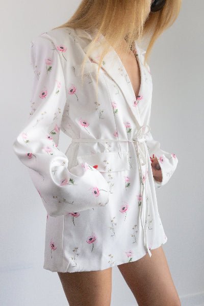 White floral-patterned pajama set on a plain background