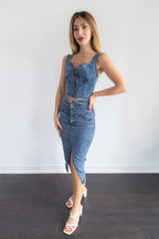 Woman wearing a denim dress with a white background